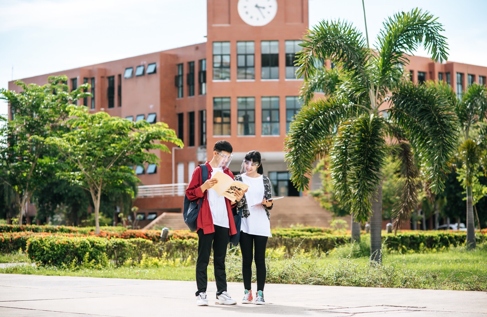 male-female-students-wear-face-chill-stand-front-university